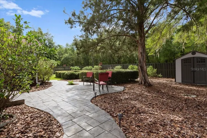 Private backyard retreat with mature shade trees.