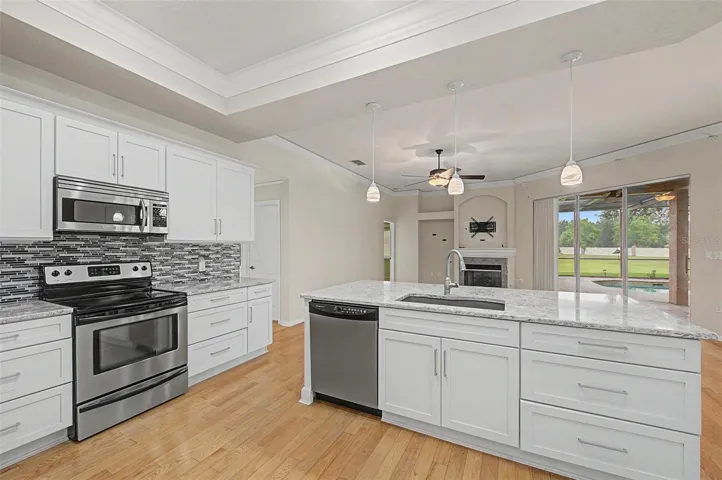 Fully functional laundry room equipped with a washer and dryer, both included with the home. The space also features a utility sink, overhead hanging rack for air-drying garments, and ample room for everyday laundry tasks, combining convenience with practical functionality.