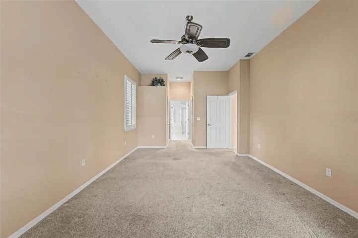 Spacious primary suite featuring a generous layout with room for a sitting area and two separate closets, providing exceptional storage and organization. Large windows fill the room with natural light, creating a bright and inviting retreat.