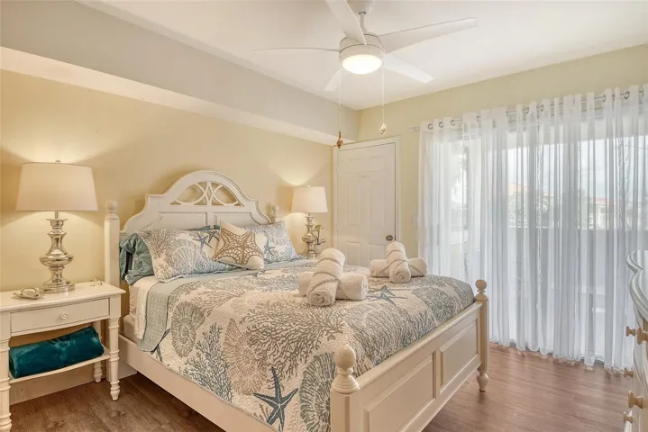 Primary bedroom with storage closet and sliding doors to porch
