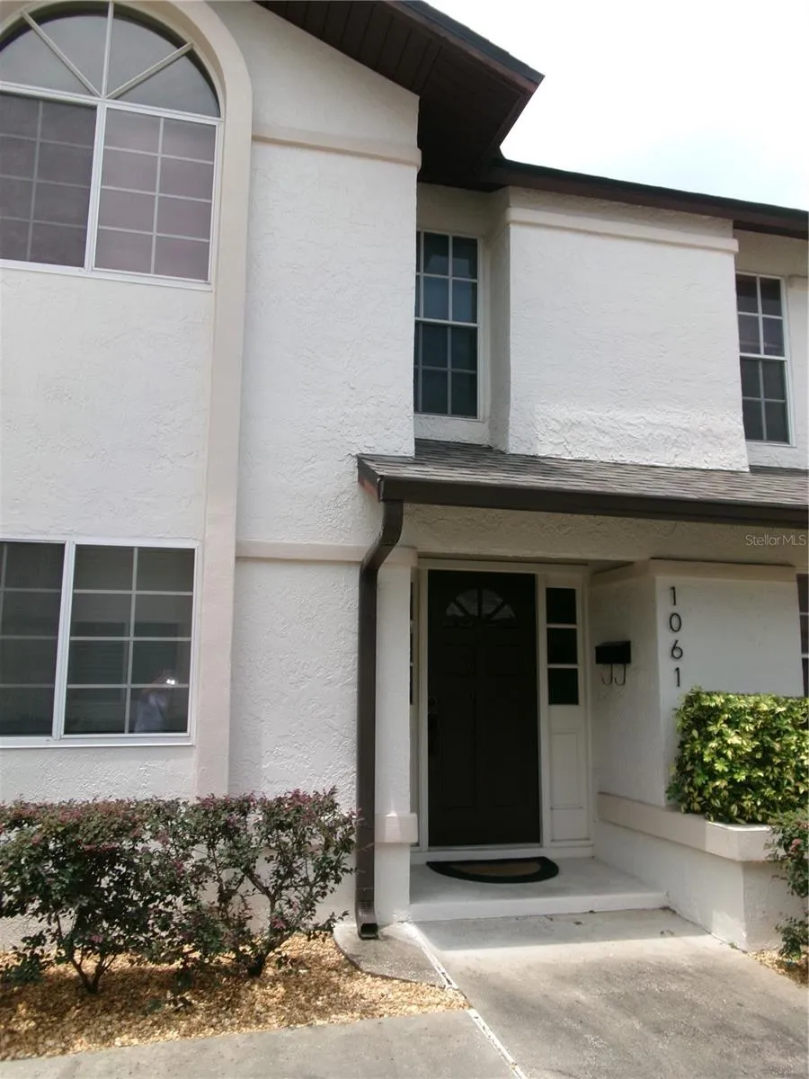 Two story stucco home with private entrance