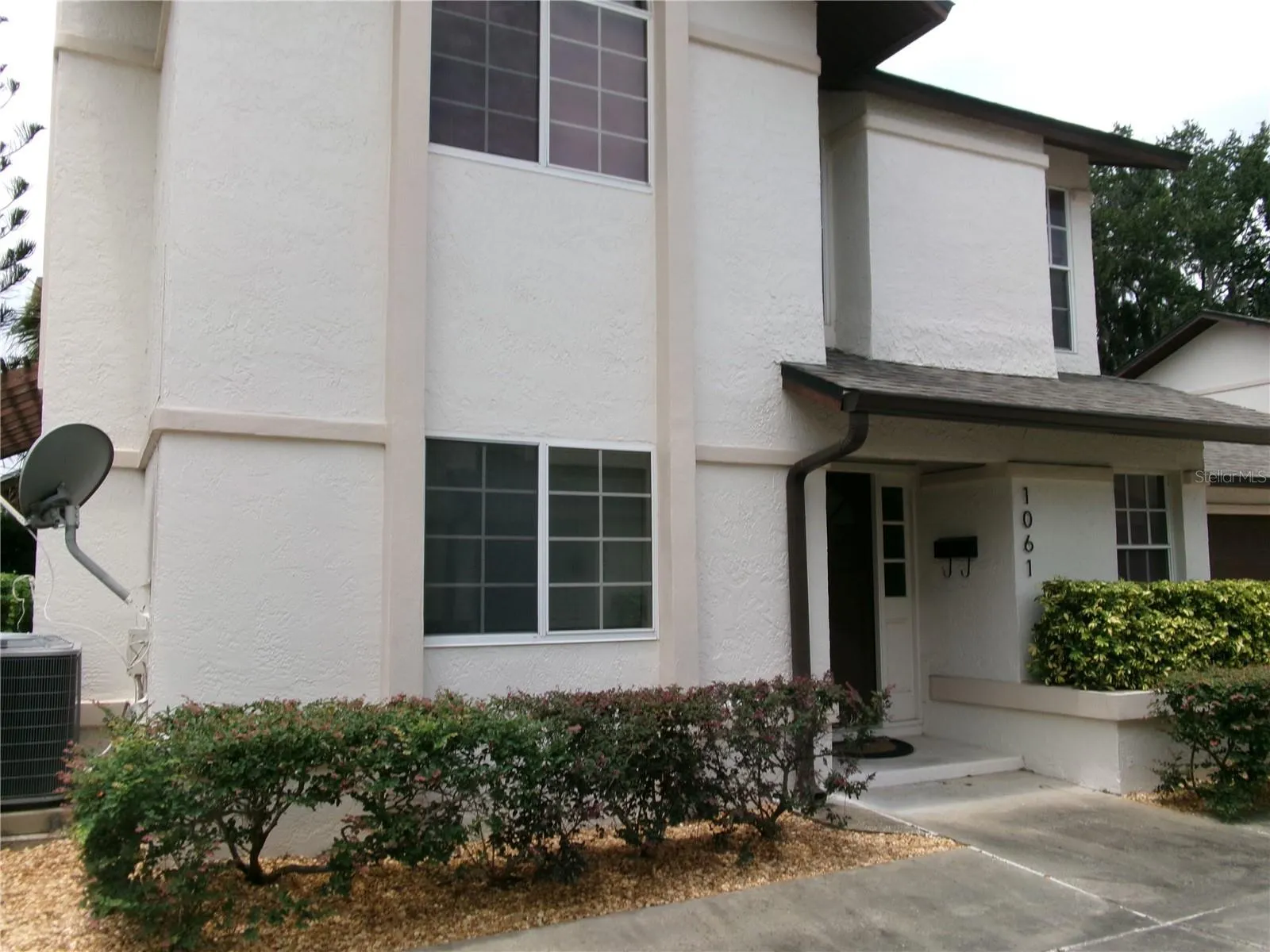 Two story stucco home with private entrance