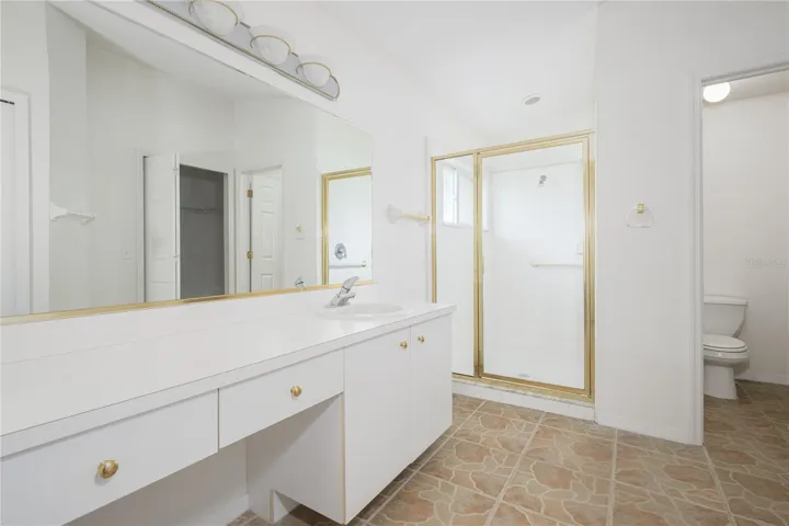 Primary bath with walk-in shower and private toilet closet
