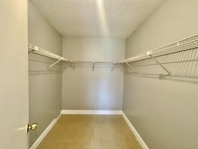 Primary bedroom walk-in closet