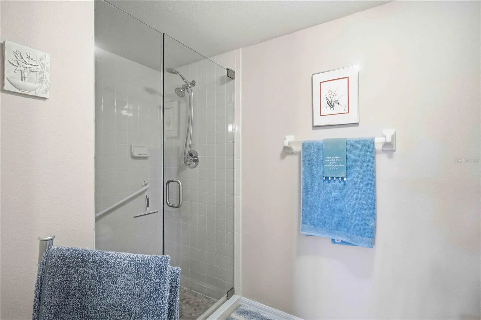 Private shower and water closet in primary bathroom.