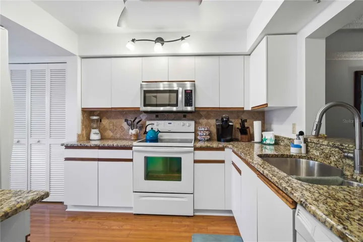 Light colored cabinets with granite countertops