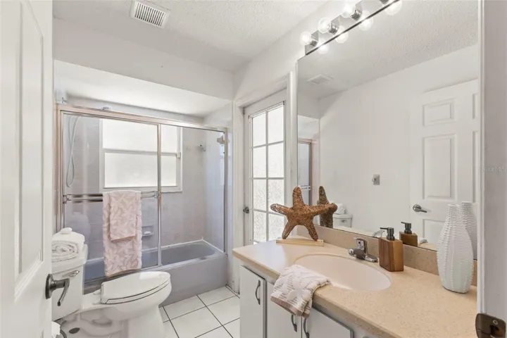 Second full bath with access to lanai/pool