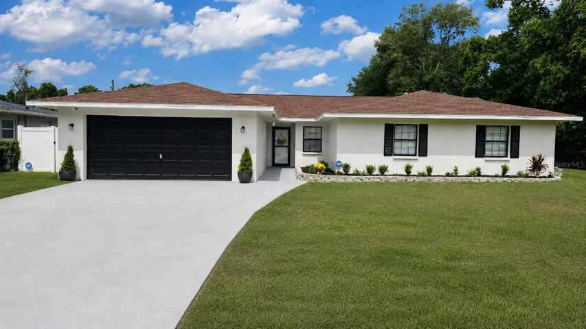 Front elevation of the 4 bedroom, 2 bath POOL HOME!