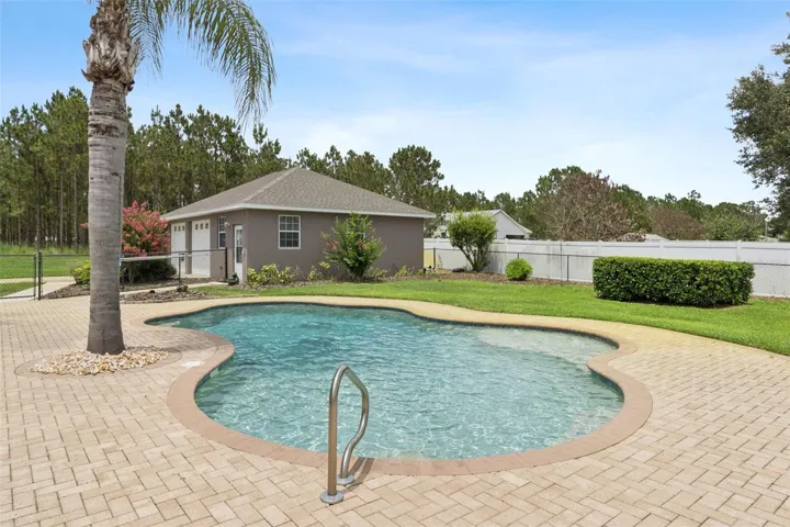 Pool view looking toward detached garage/workshop