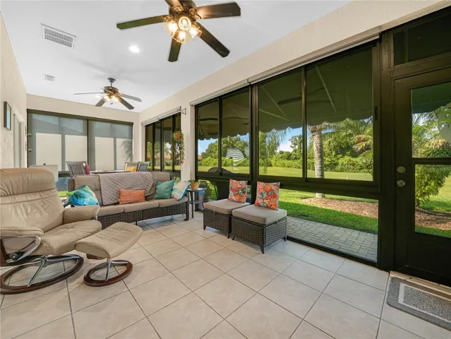 Florida Room with Tile Flooring and Awning on the Exterior of the Home