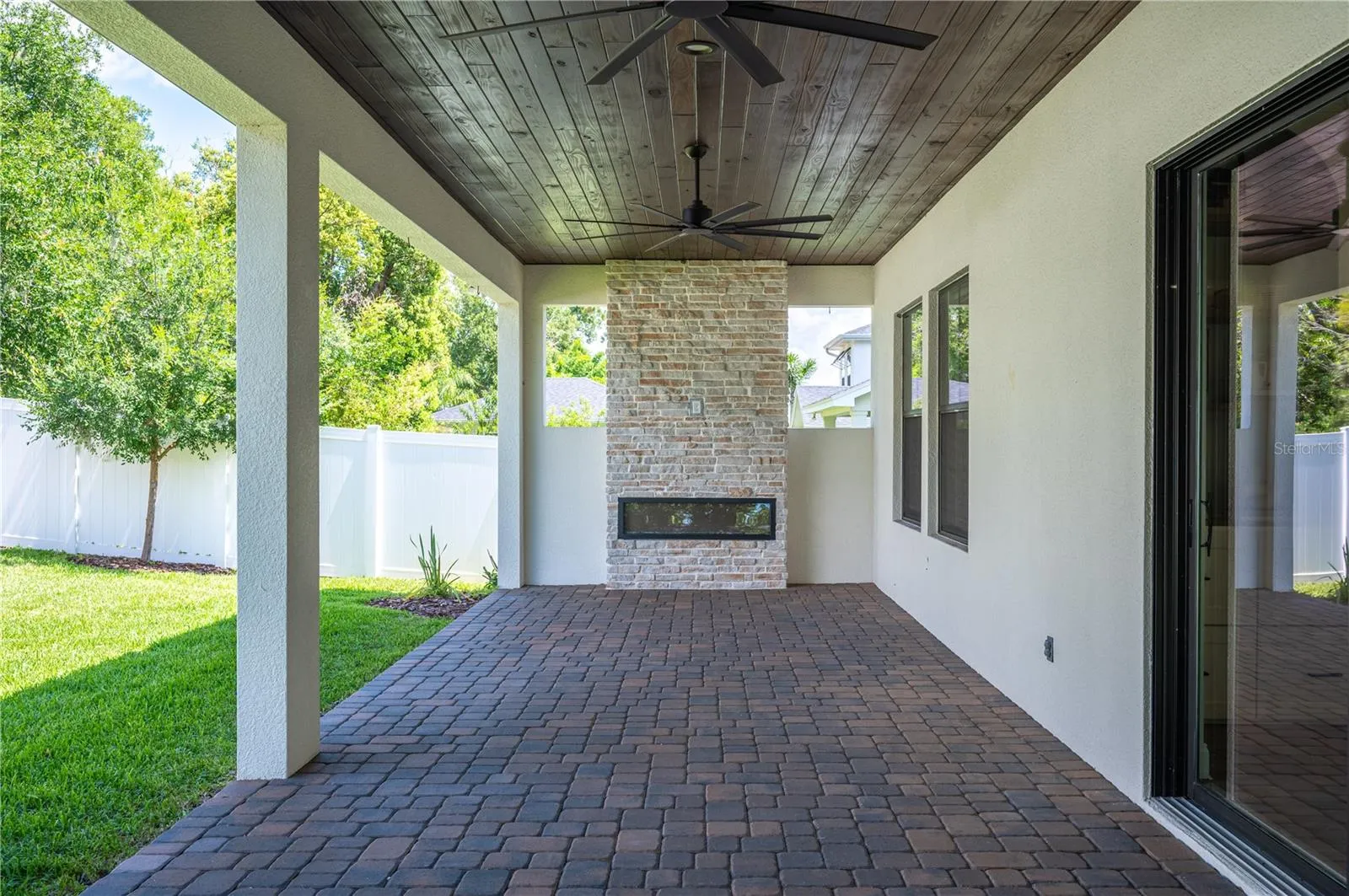 45ft paver lanai with stone fireplace and outdoor serving area