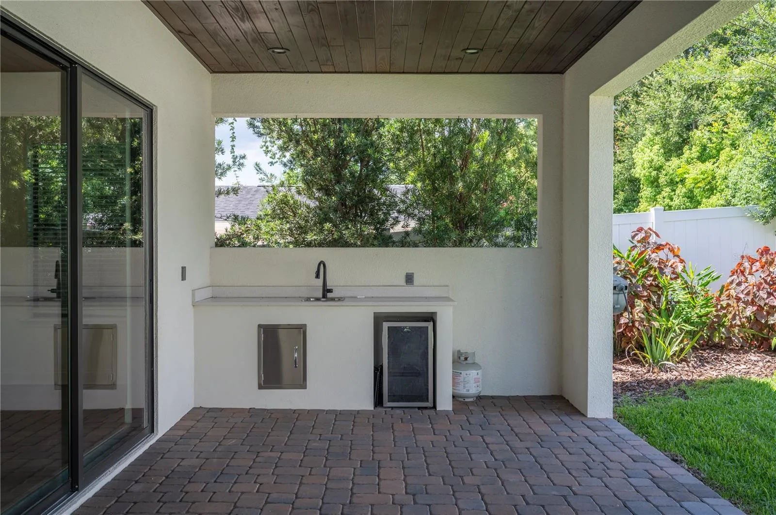 45ft paver lanai with stone fireplace and outdoor serving area