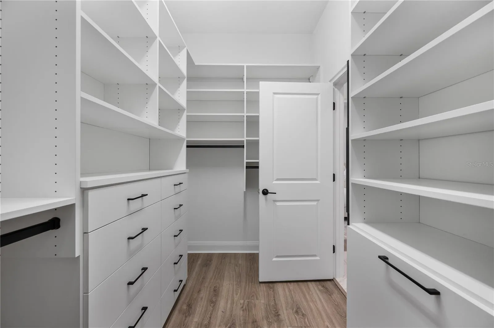 Walk-in closet with custom California Closets system