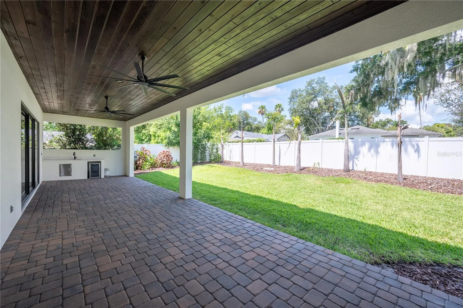 45ft paver lanai with stone fireplace and outdoor serving area