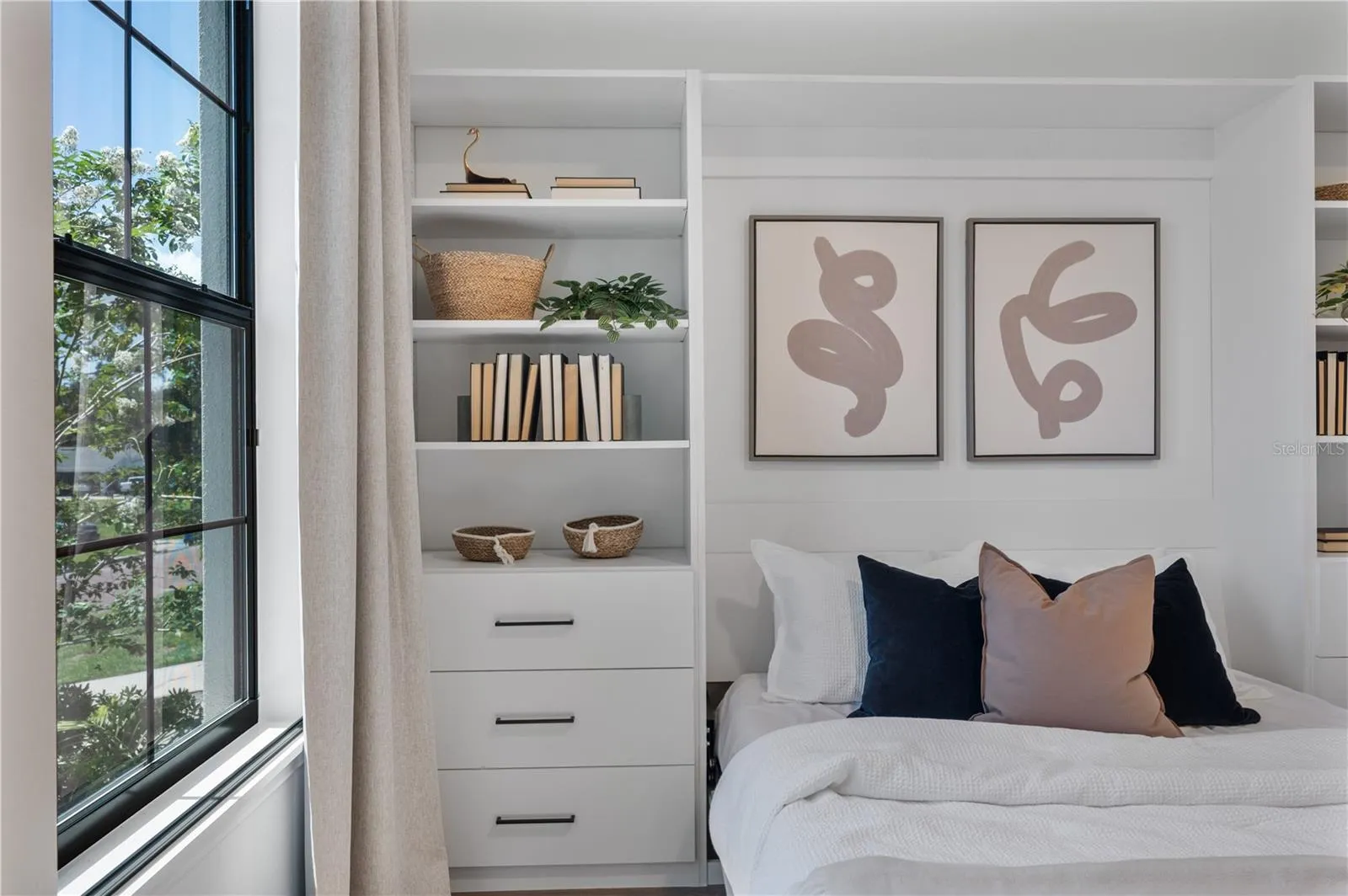 Custom built Murphy queen bed at front of home with built in storage system