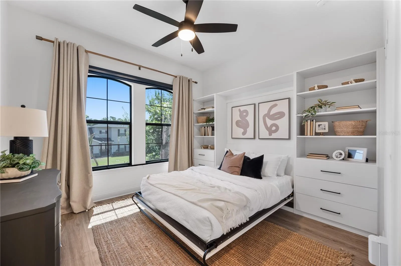 Custom built Murphy queen bed at front of home with built in storage system