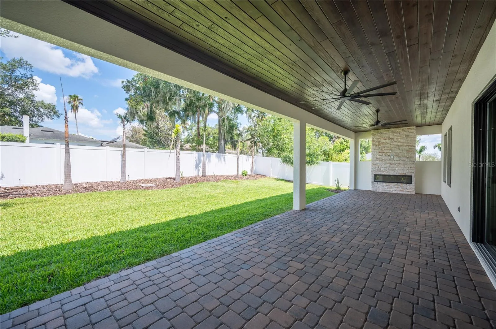 45ft paver lanai with stone fireplace and outdoor serving area