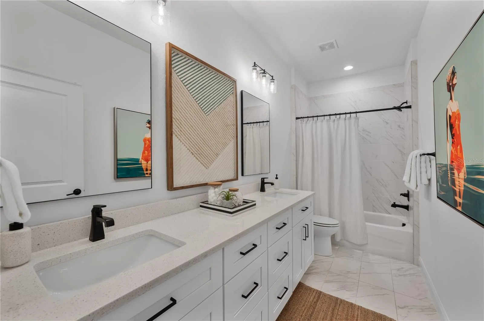 Upstairs full bathroom with dual sink vanity and tub-shower