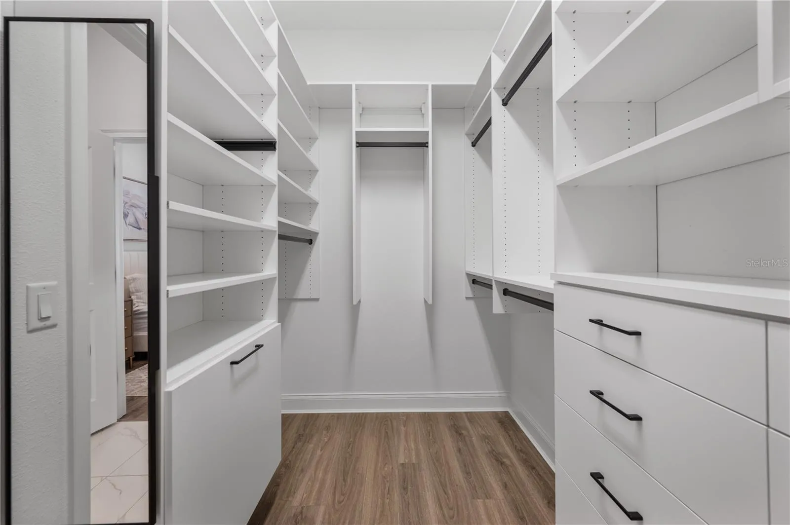 Walk-in closet with custom California Closets system