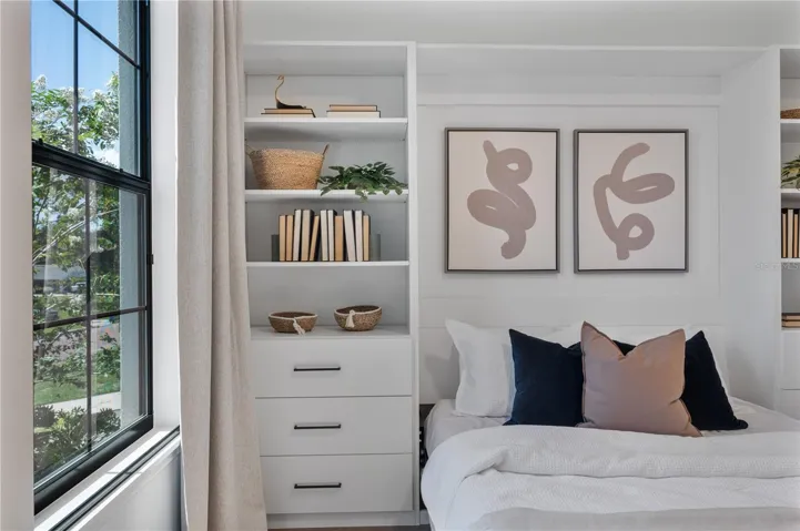 Custom built Murphy queen bed at front of home with built in storage system