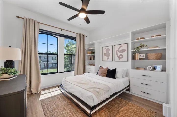 Custom built Murphy queen bed at front of home with built in storage system