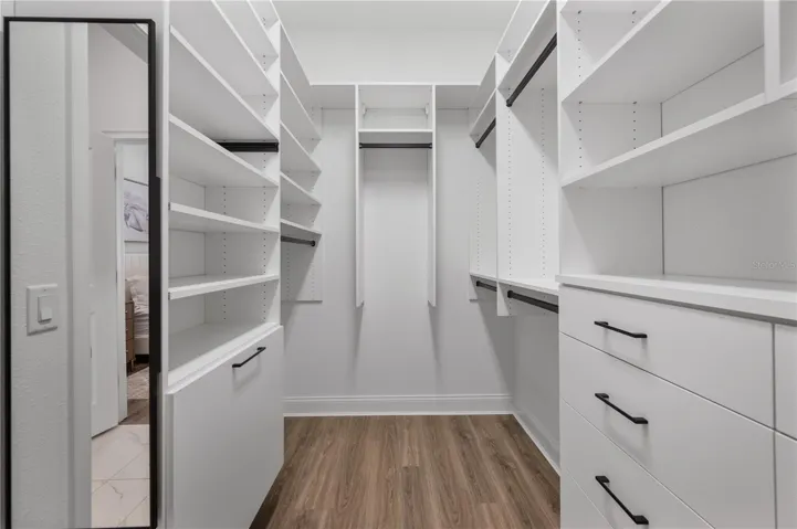 Walk-in closet with custom California Closets system