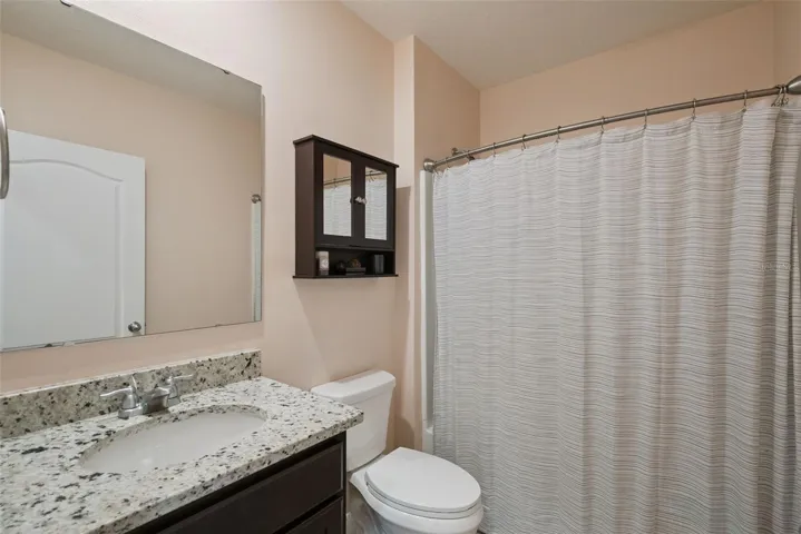 Downstairs full bath, adjacent to mother-in-law or guest suite, tucked away for privacy