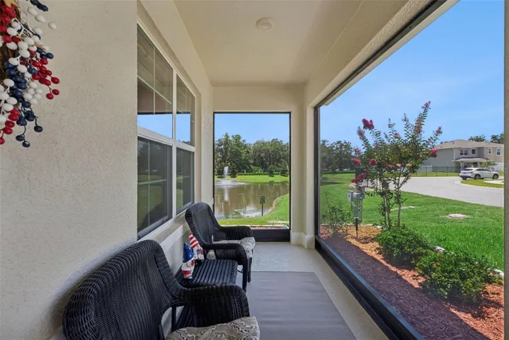 Relax on your screened front porch beside the pond