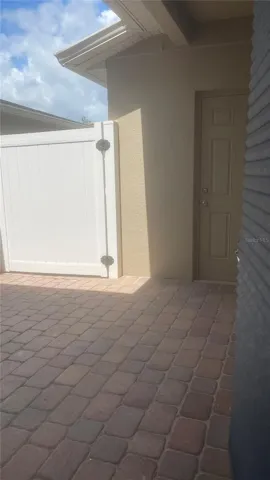 Private patio with covered garage path