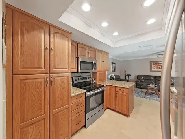 Oak Cabinets, Granite counter tops and Travertine tile, recessed lighting and cove moldings!