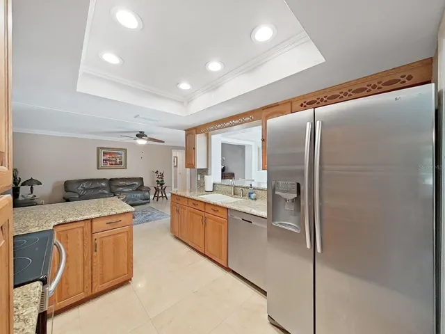 Entertainment friendly floor plan! Pass through window to the sunlit Florida room overlooking the sparkling pool!