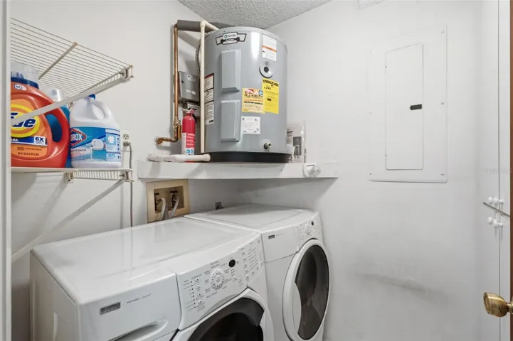 Laundry room and pantry with a newer water heater
