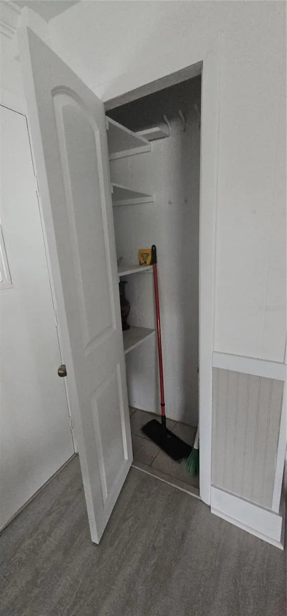 Additional storage in a living room behind the front door.