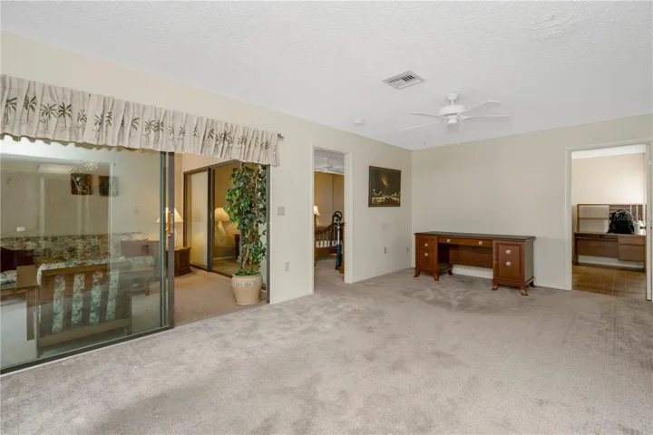 Living room leading into Primary bedroom, Florida room, and Laundry room