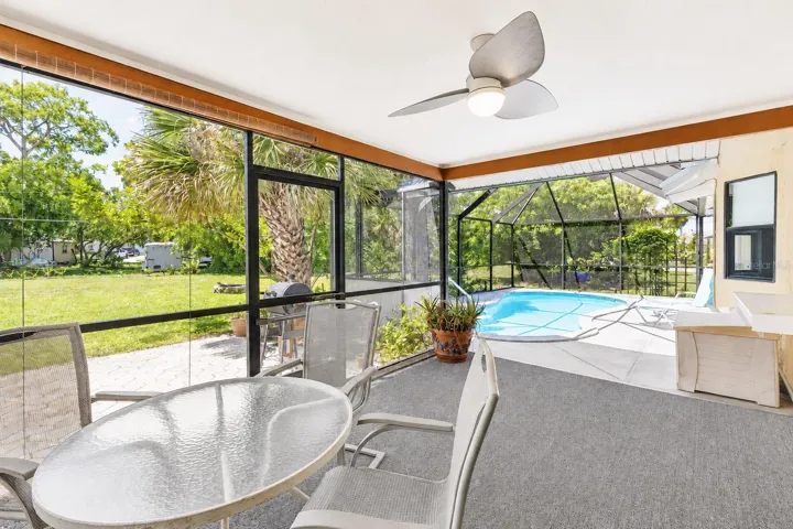 Large Covered Lanai Space Looking to Yard and Pool