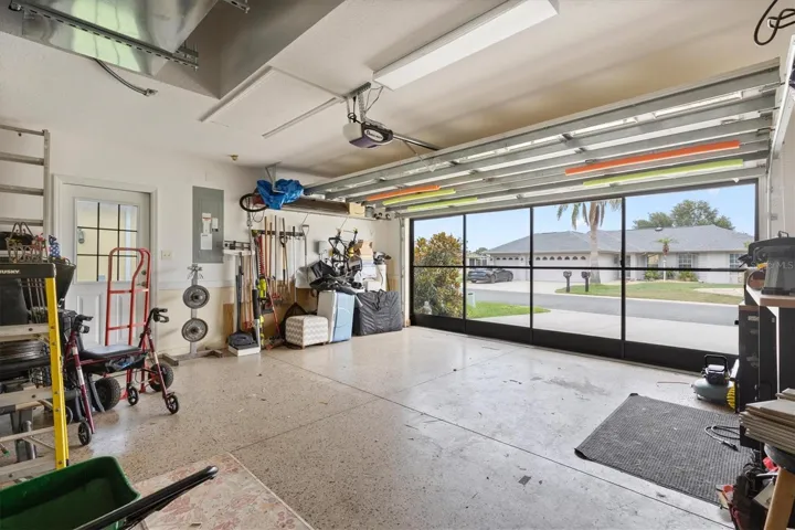 Two car garage with slidding screend door and utility door.