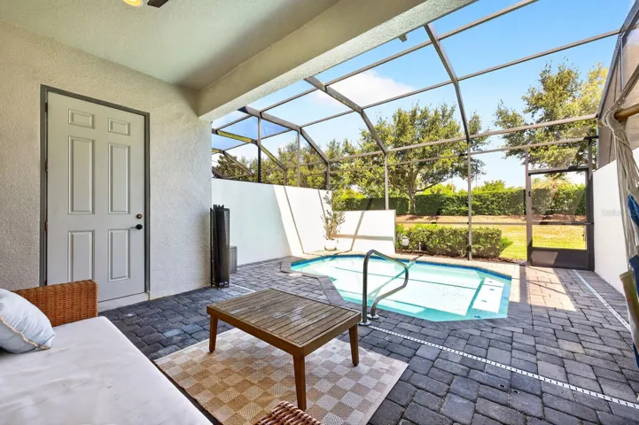 Covered lanai overlooks the screened pool.