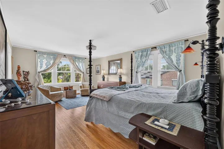 Primary en-suite bedroom with sitting area overlooking lake