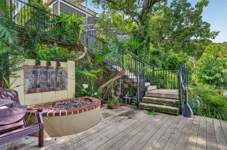 Water fall and fire pit on lakefront deck