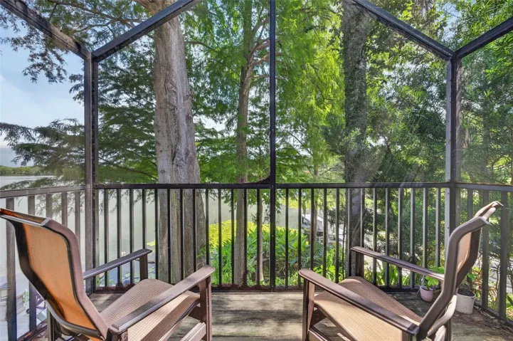 Enjoy morning coffee or sunsets with a glass of wine overlooking lake from guest house screened porch