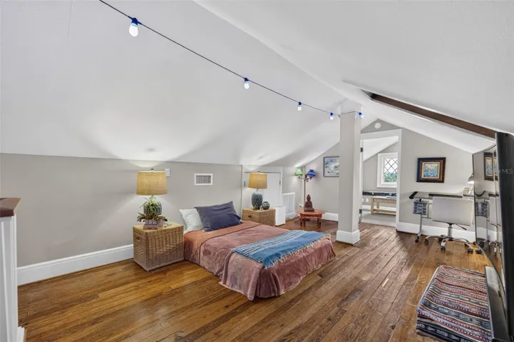 Attic bedroom is private retreat with closet/sitting room overlooking lake. Complete with heart pine wood floors.
