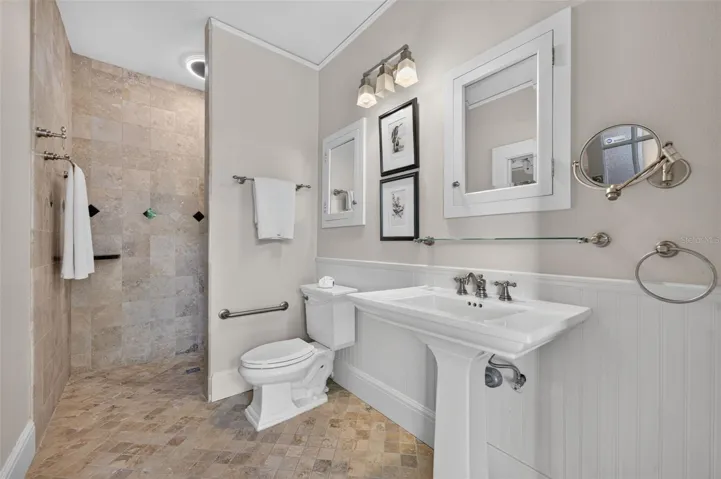 Walk-in shower, pedestal sink and private entrance to outdoor living spaces in the guest house/in-law suite