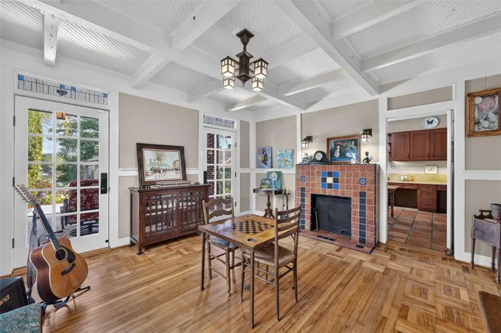 Beautiful parquet floors and stained glass windows along with coffered ceilings create cozy casual living room or music room for entertaining