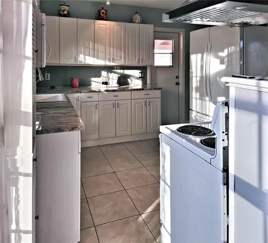 Kitchen looking toward carport door