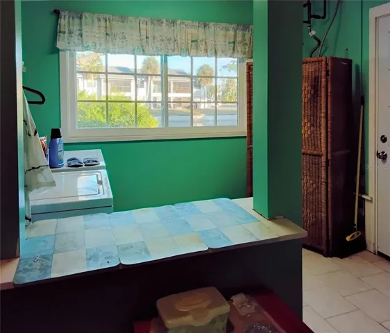 Window in laundry room overlooking backyard and canal