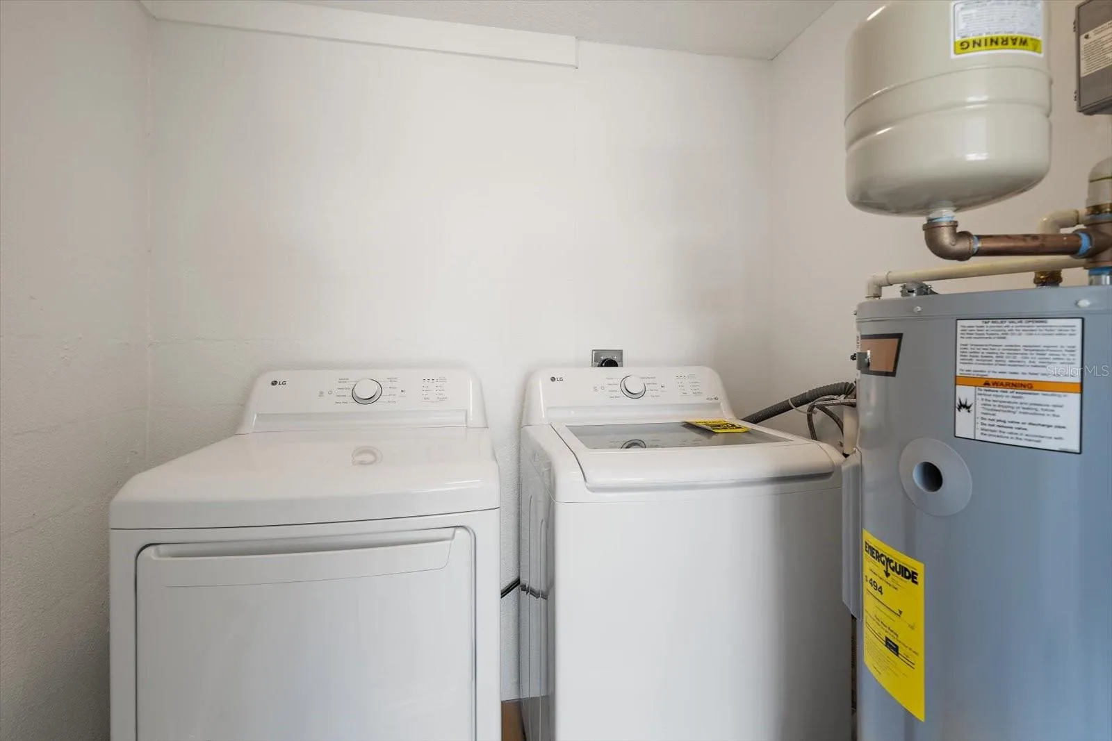Laundry room with new washer, dryer, and water heater