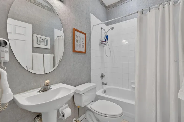 Bathroom 2 with full tub/shower and pedestal sink