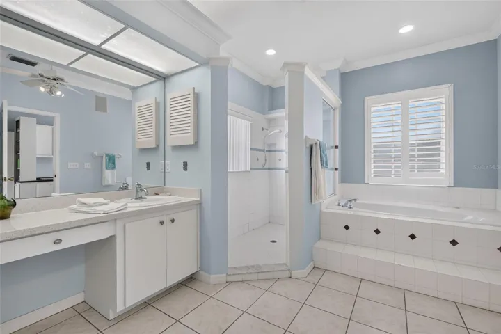 Primary bathroom with separate vanities, makeup counter, large shower and jetted tub