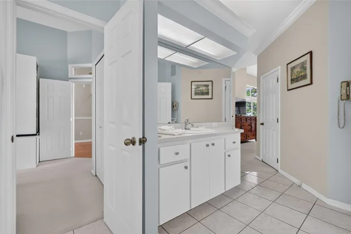 Primary bathroom has dual points of entry; from the home office (left) and primary bedroom (right)