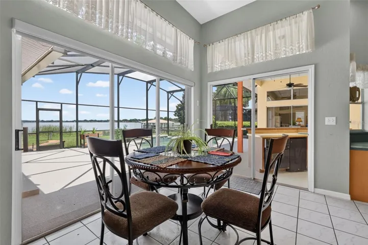 Dinette with dual glass sliders with views of the pool and Lake